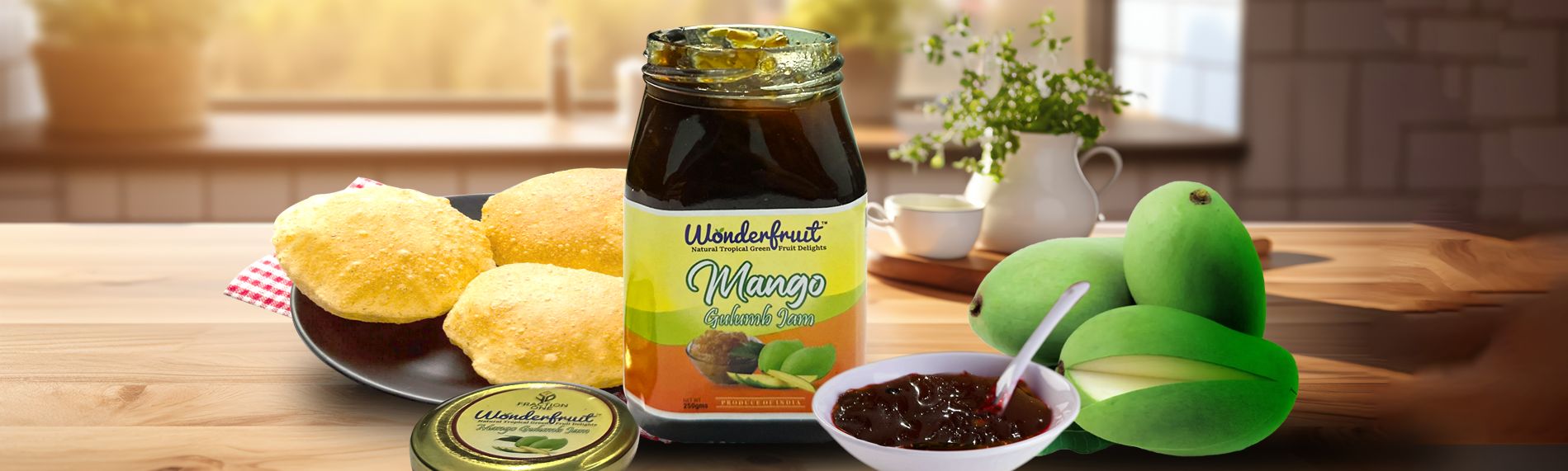 Wonderfruit Mango Gulumb Jam jar with puris, a bowl of jam and fresh green mangoes